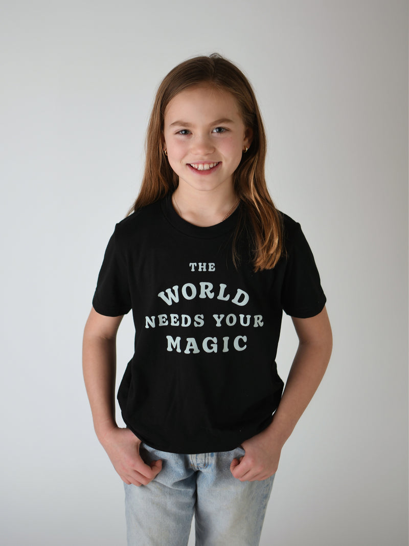 THE WORLD NEEDS YOUR MAGIC KIDS TEE IN BLACK